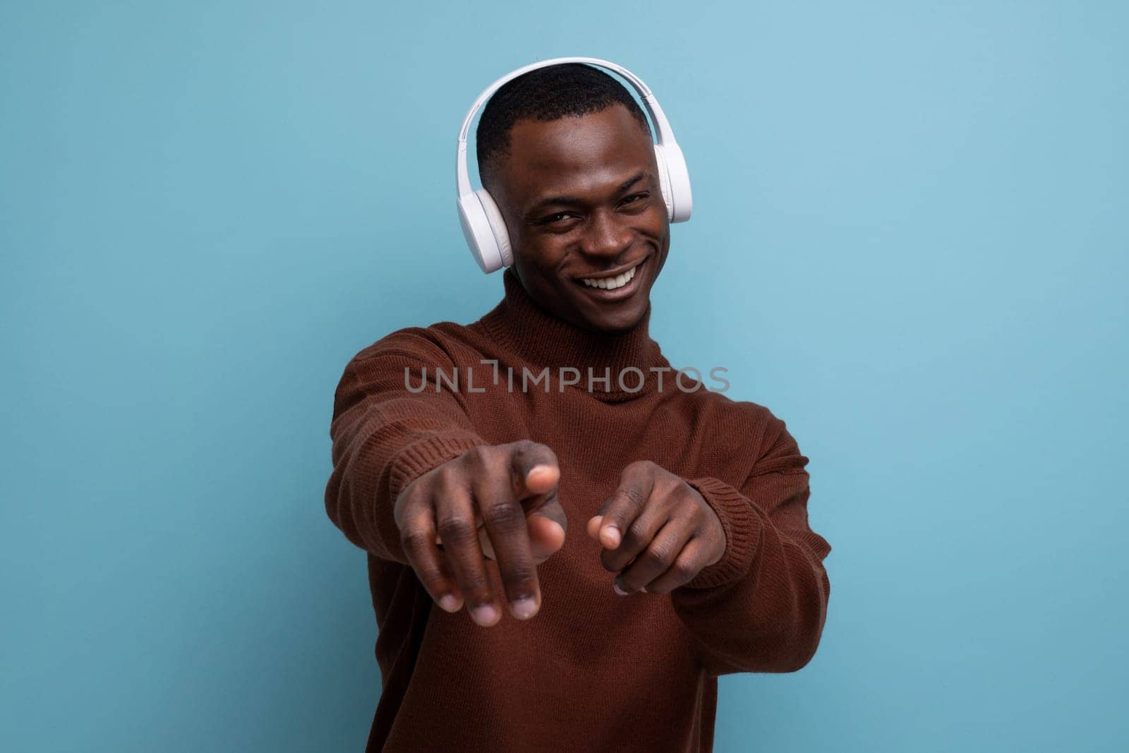 25 year old young American man with big white wireless headphones in front of copy space.