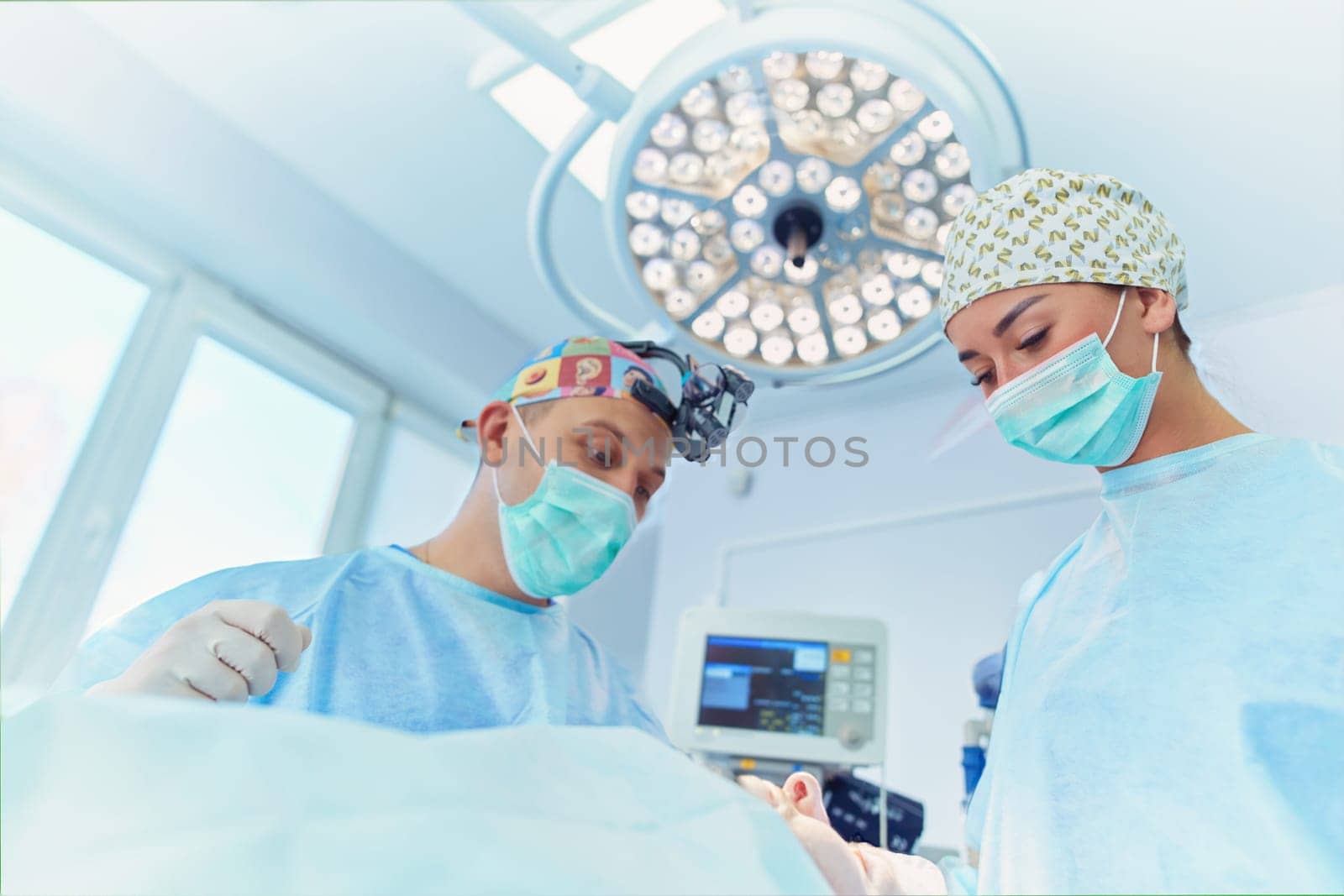 Team surgeon at work in operating room.