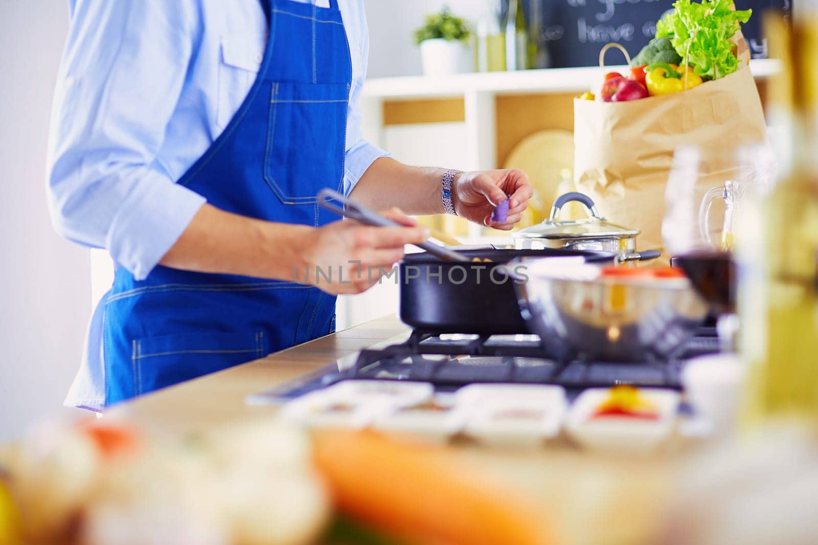 Man preparing delicious and healthy food in the home kitchen.