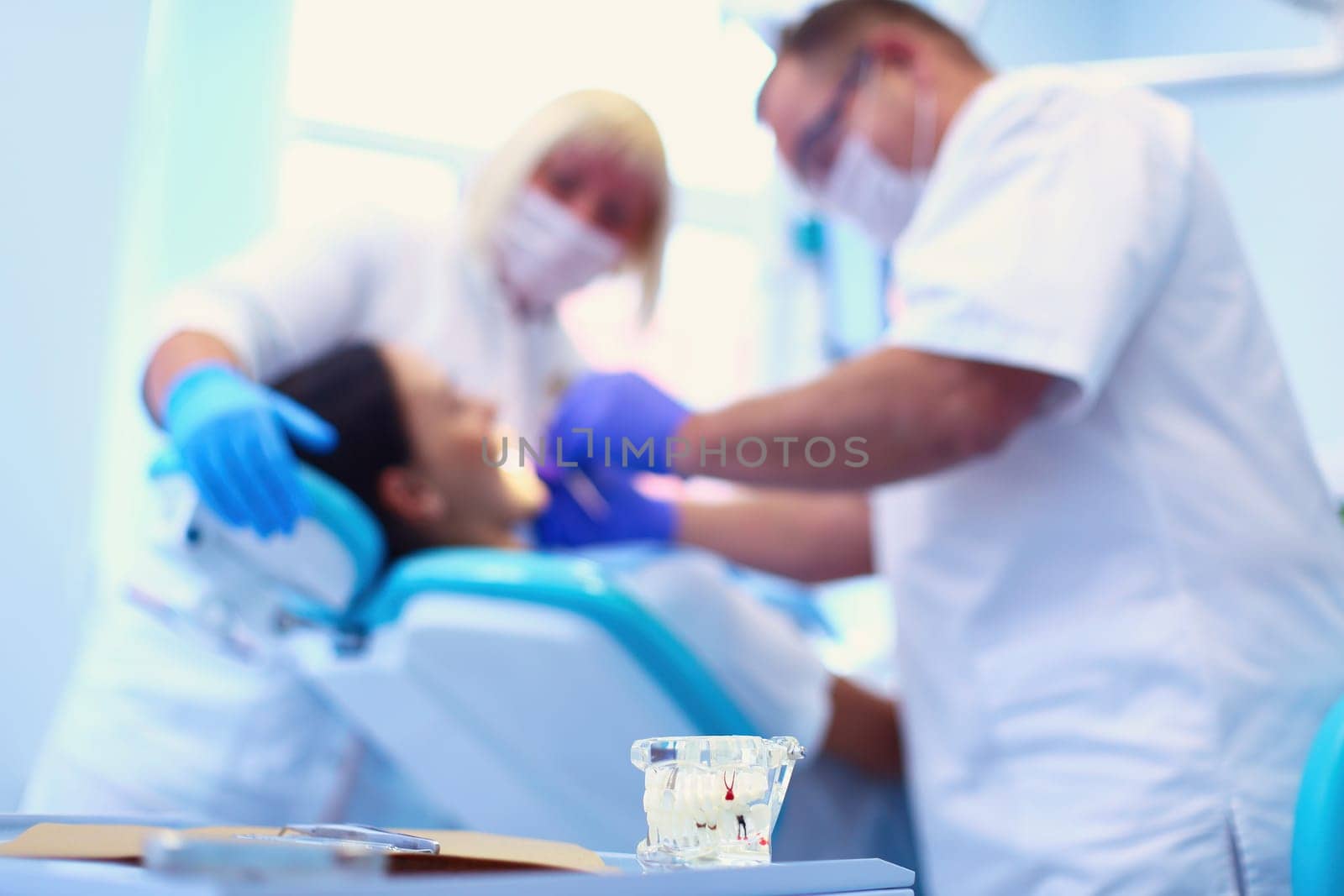 Dentist man with patient woman in clinic by lenets