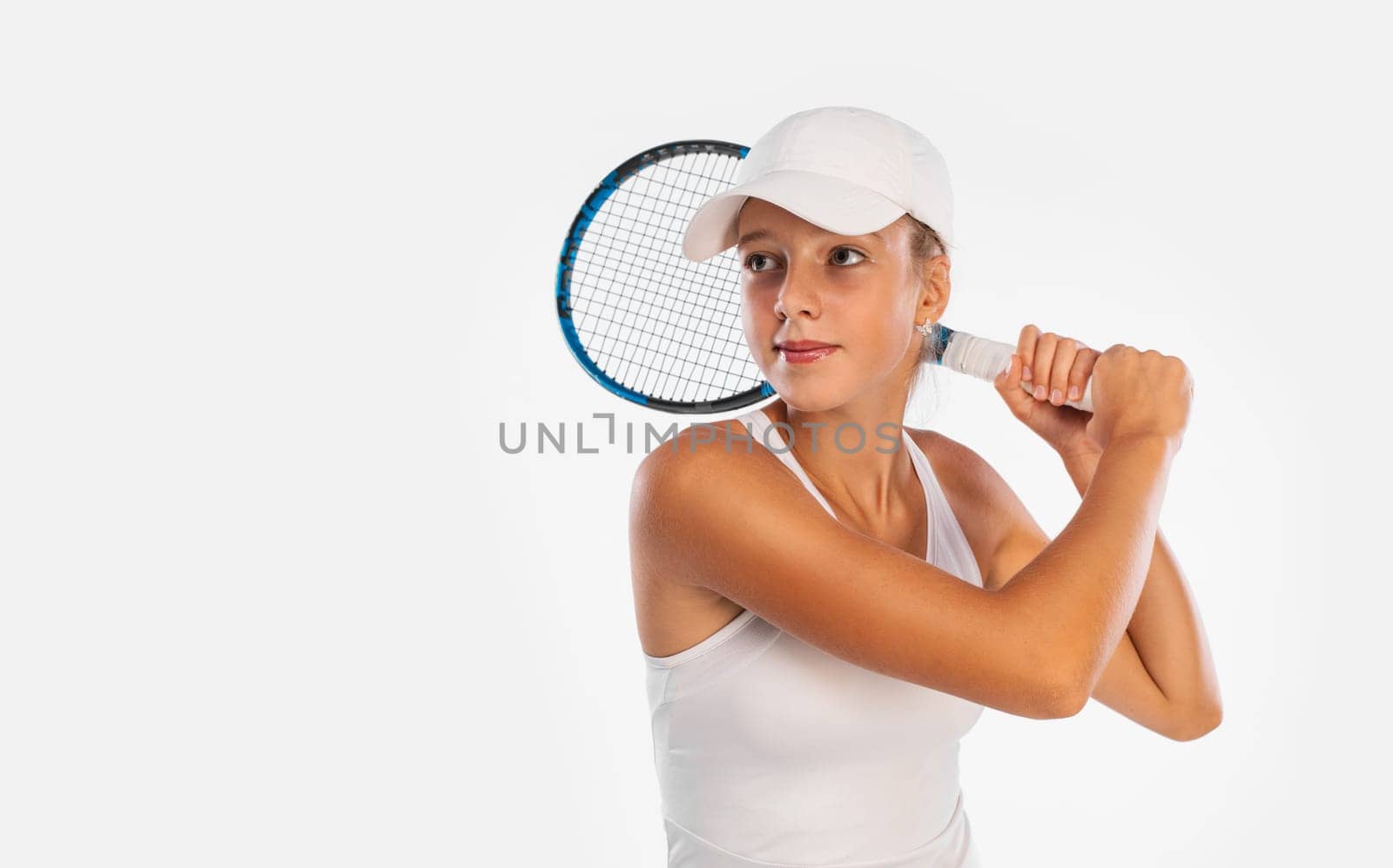 Tennis player. Beautiful girl teenager and athlete with racket in sporswear and hat on tennis court. Sport concept
