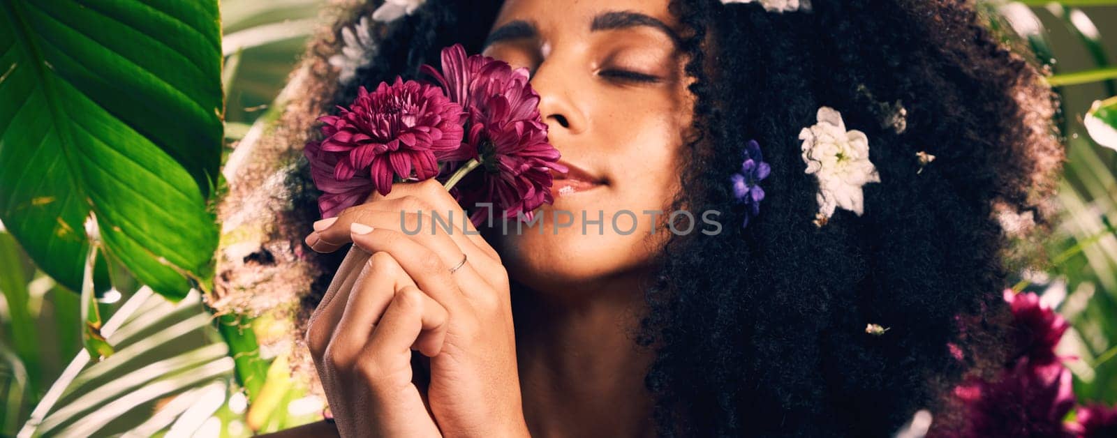 Flowers, beauty and scent by woman in studio for wellness, skincare and creative advertising in jungle. Face, skin and girl model relax in zen, peace and product from nature, forest and aesthetic.