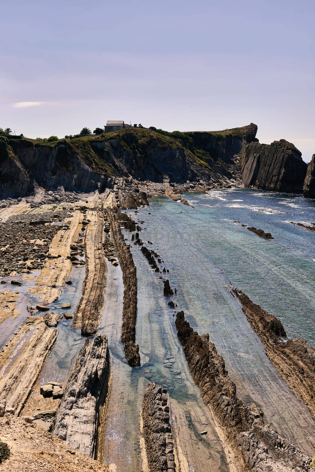 Broken coast at Liencres Cantabria , on a sunny summer day, low tide. Empty beach, low tide, clear sky, aerial view