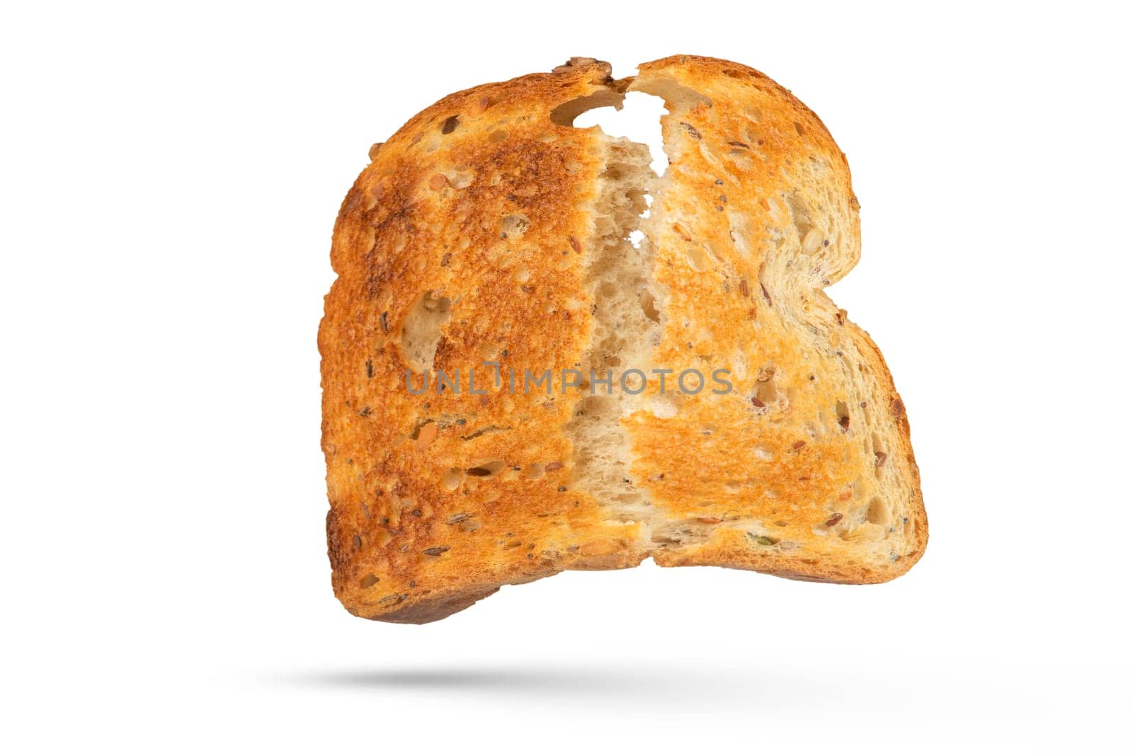 The isolate of a slice of white bread is broken into two parts. Toaster fried bread isolated on white background. The concept of a small, dietary crispy breakfast