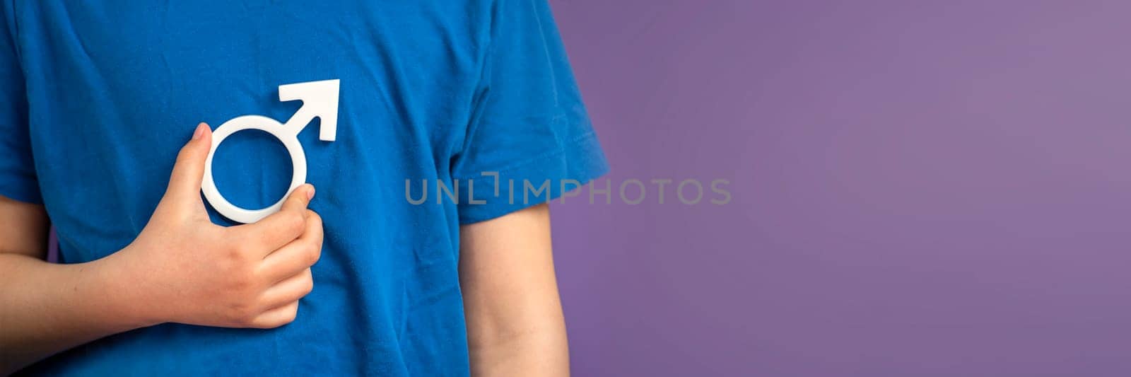 Gender symbol of a man. Symbol of a man in his hands on a purple background with copy space. The concept of male leadership or gender equality. High quality photo