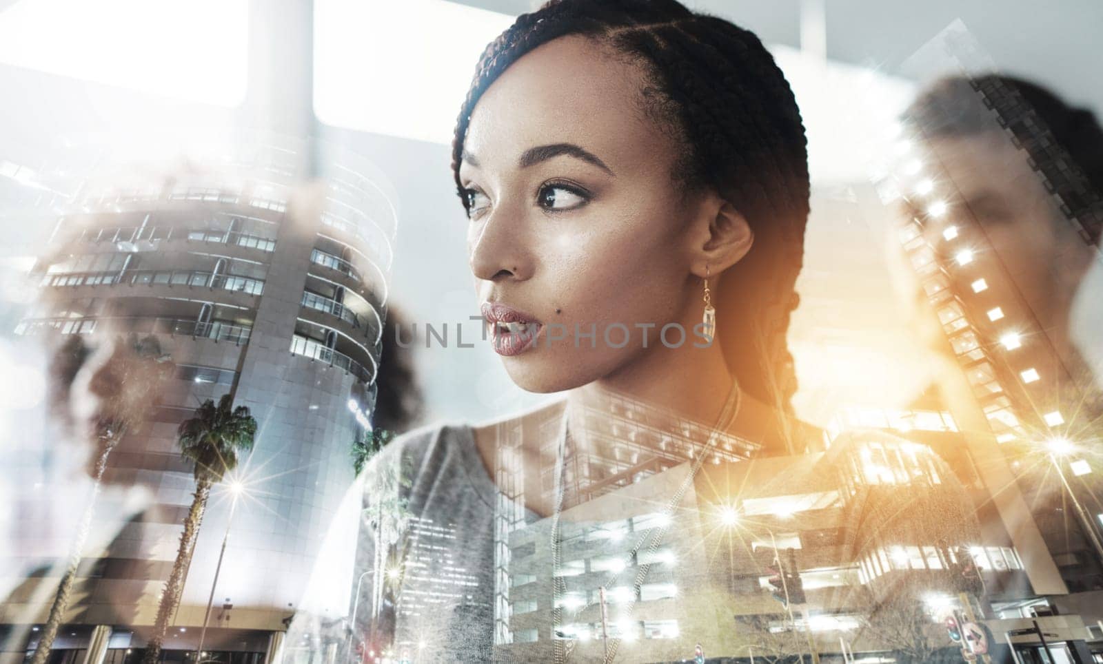 Multiple exposure shot of businesspeople superimposed over a cityscape.