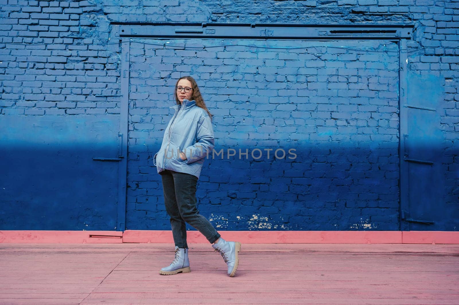 Portrait of a stylish woman in blue jacket. Spring outdoor portrait.