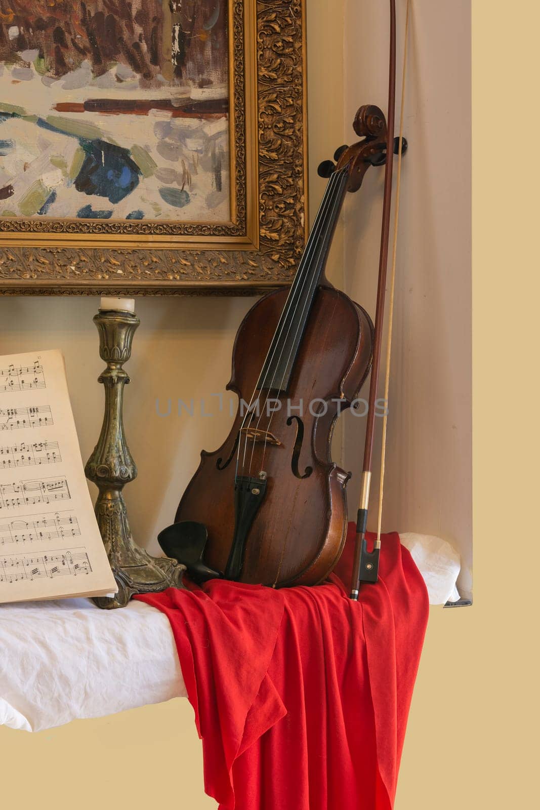 Violin leaning against the wall under the painting