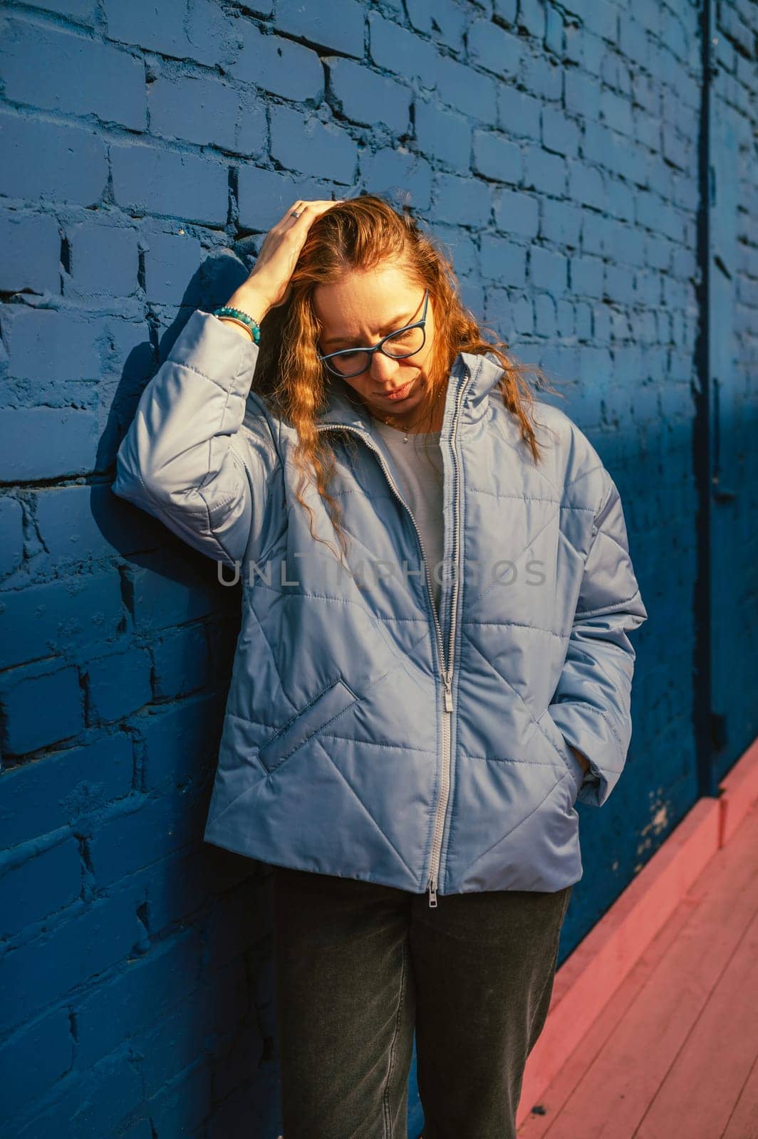 Portrait of a stylish woman in blue jacket. Spring outdoor portrait.