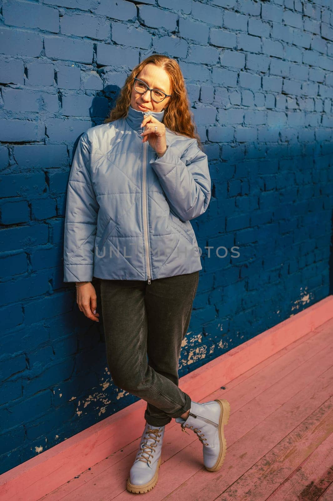 Portrait of a stylish woman in blue jacket. Spring outdoor portrait.