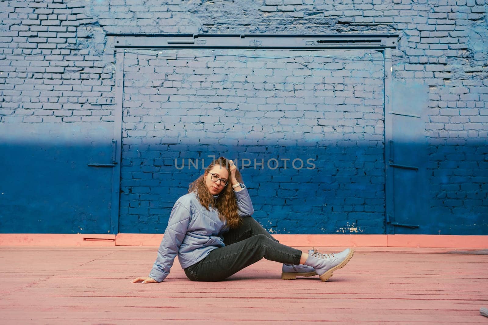 Portrait of a stylish woman in blue jacket. Spring outdoor portrait.