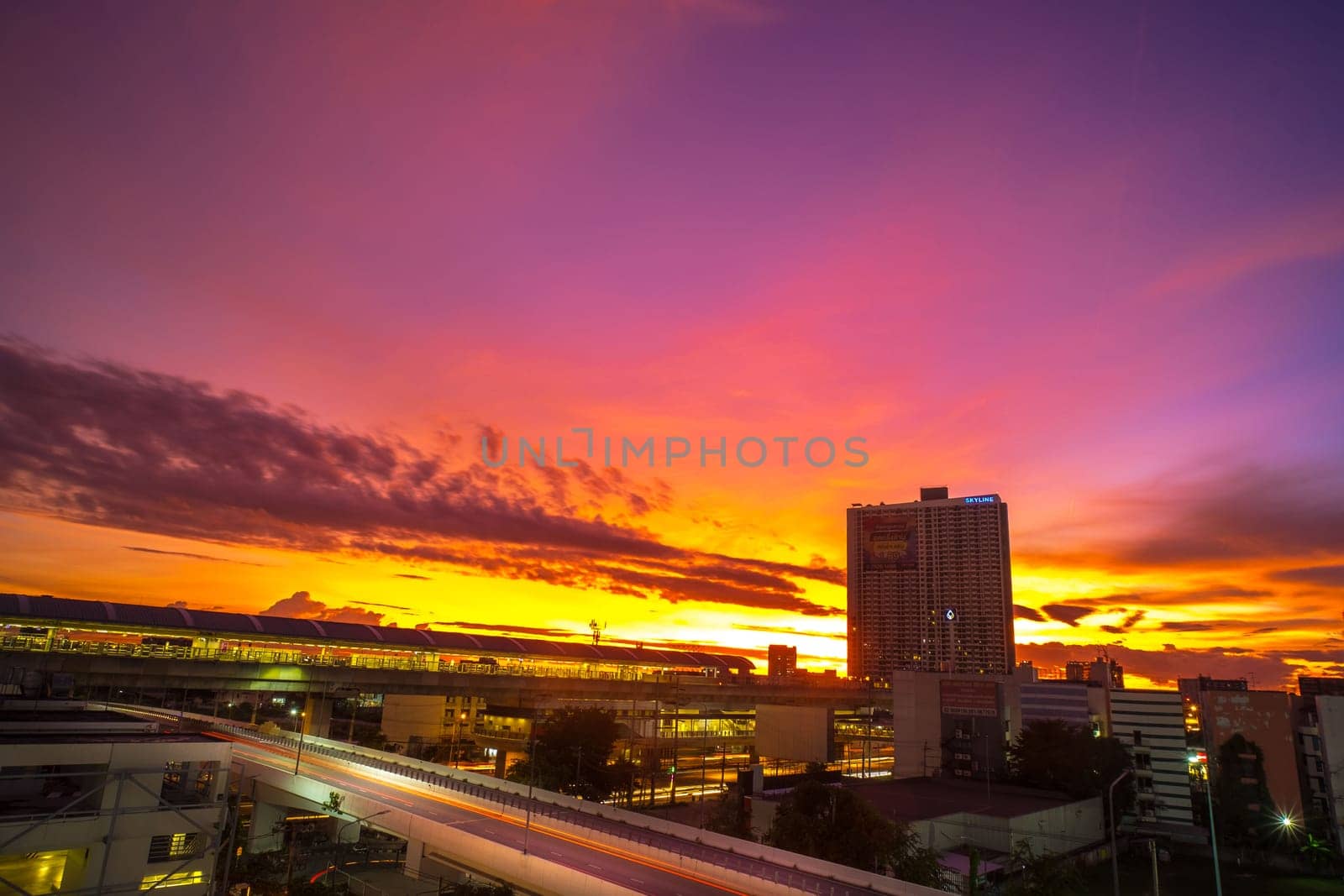 A beautiful and dramatic panoramic photograph of city skyline, taken on a golden evening after sunset.