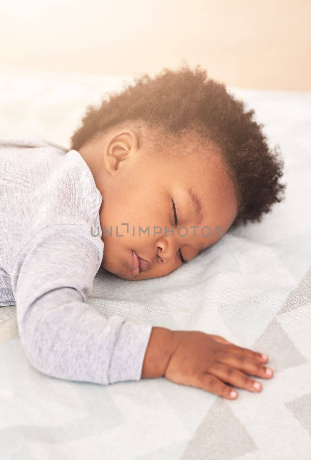 Comfort, bed and baby sleeping in home on blanket for rest, nap time and dreaming in nursery. Childcare, newborn and cute, tired and African child in bedroom sleep for comfortable, relaxing and calm by YuriArcurs