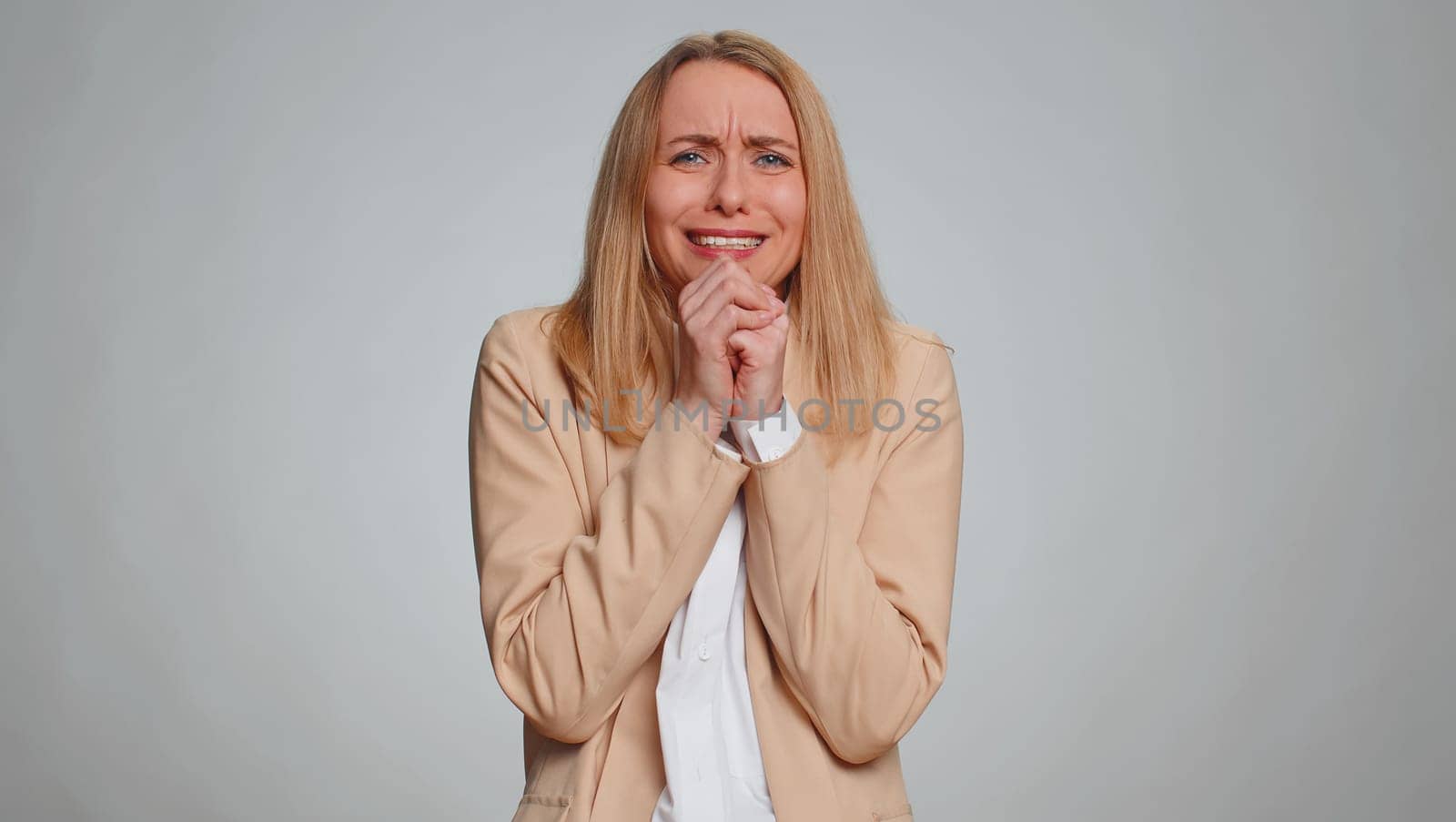Scared fearful businesswoman terrified about danger problems, suffering phobia, anxiety disorder, expresses fear, waving no, insecure, stress, panic. Female girl in suit. Woman on gray background