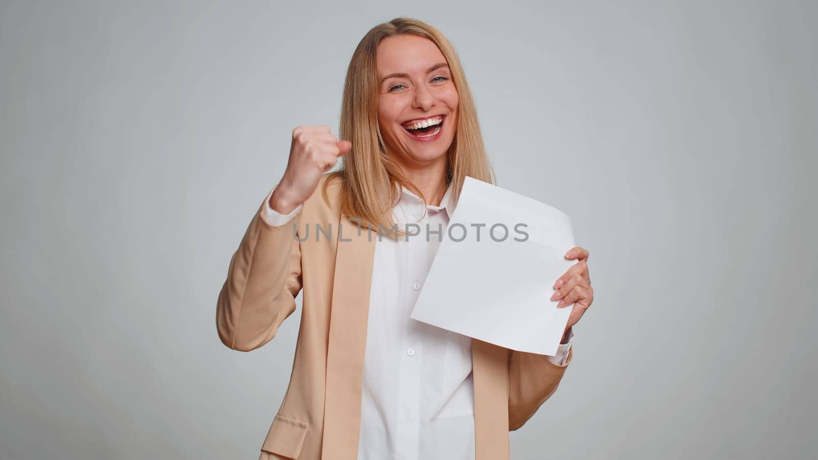 Business woman in formal suit open envelope take out letter reads it feel happy. Girl career growth advance promotion, bank loan approve, monetary award long-awaited invitation great news, lottery win