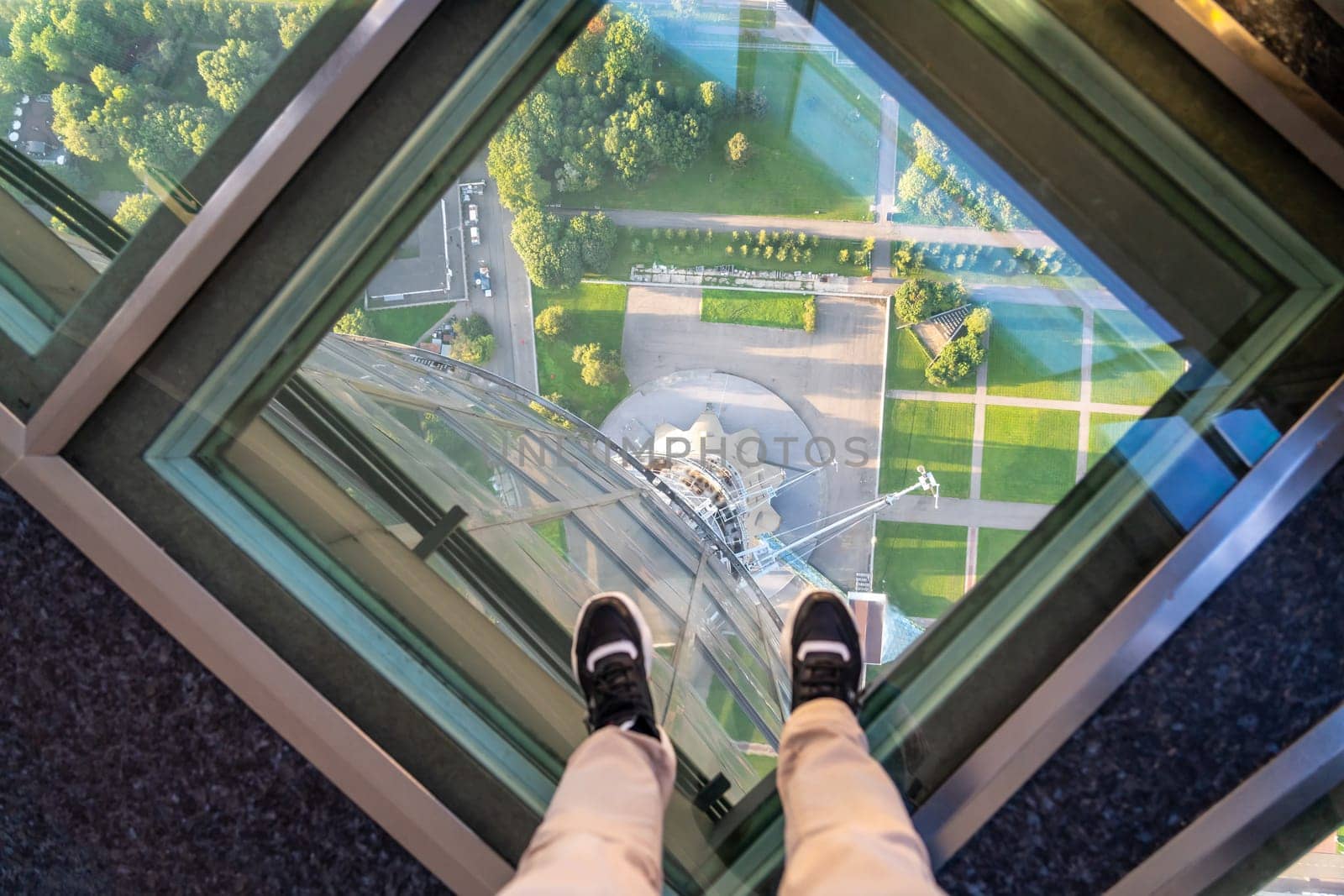 Female feet on glass floor at the Ostankino tower in Moscow, Russia by Mariakray