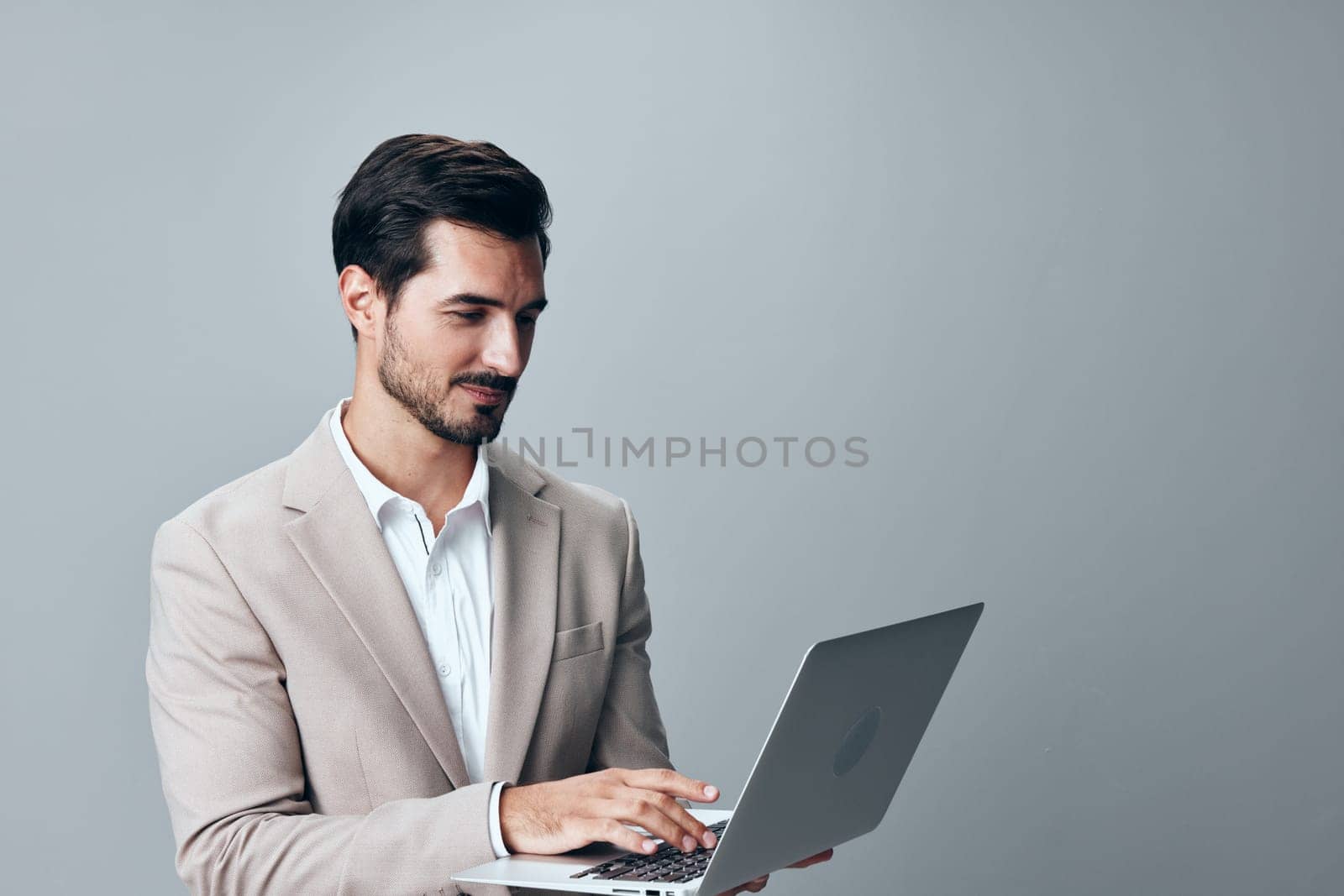 internet man business copyspace computer model laptop job young professional typing beige entrepreneur freelancer adult smiling smile portrait suit wireless network