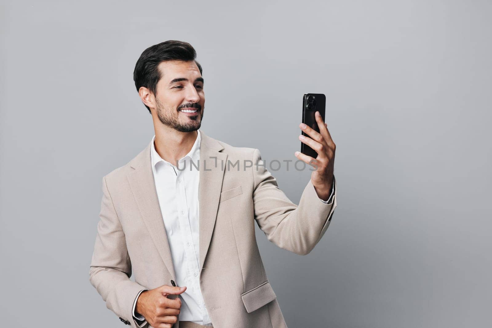 man business phone portrait call smile suit hold smartphone happy online by SHOTPRIME