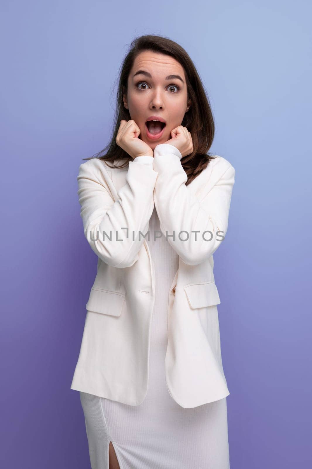 upset sad brunette young woman in a dress and jacket with a grimace.