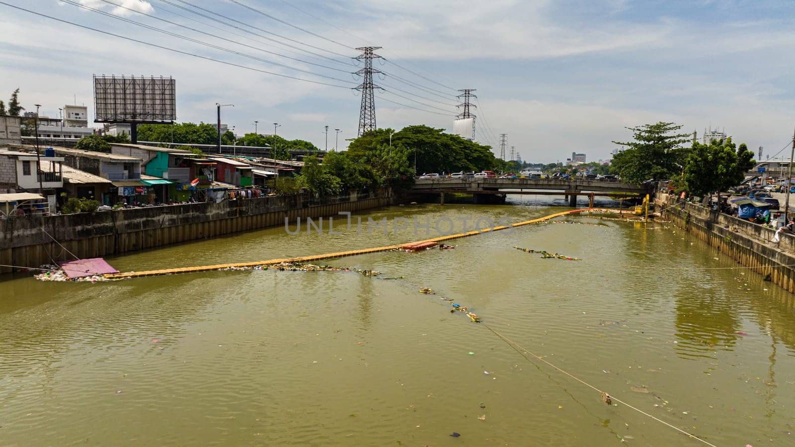 Polluted Ciliwung river with garbage in the slums of Jakarta, Indonesia.