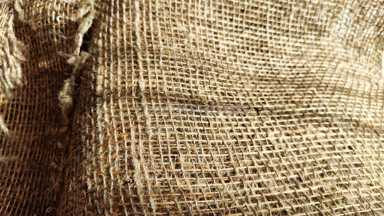 Natural fabric texture, frame and background of burlap. Rough crumpled burlap background. Selective focus