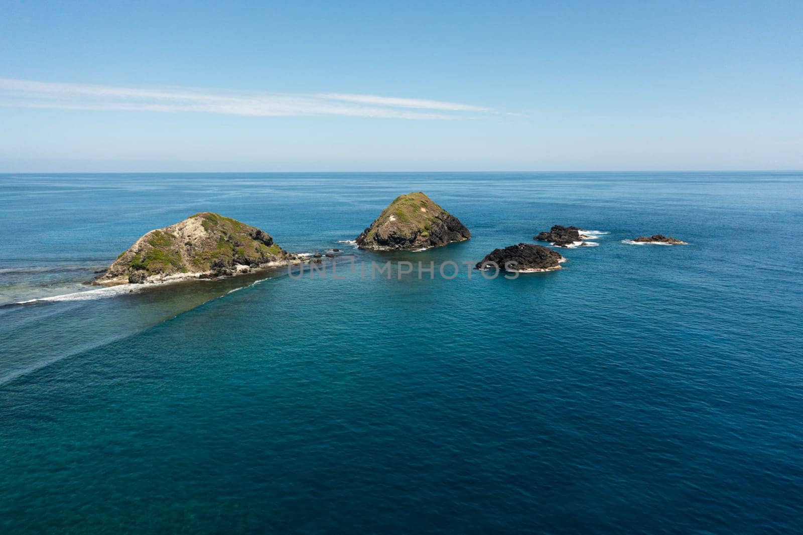 Aerial view of rocky islands and blue ocean. Seascape in the Philippines.