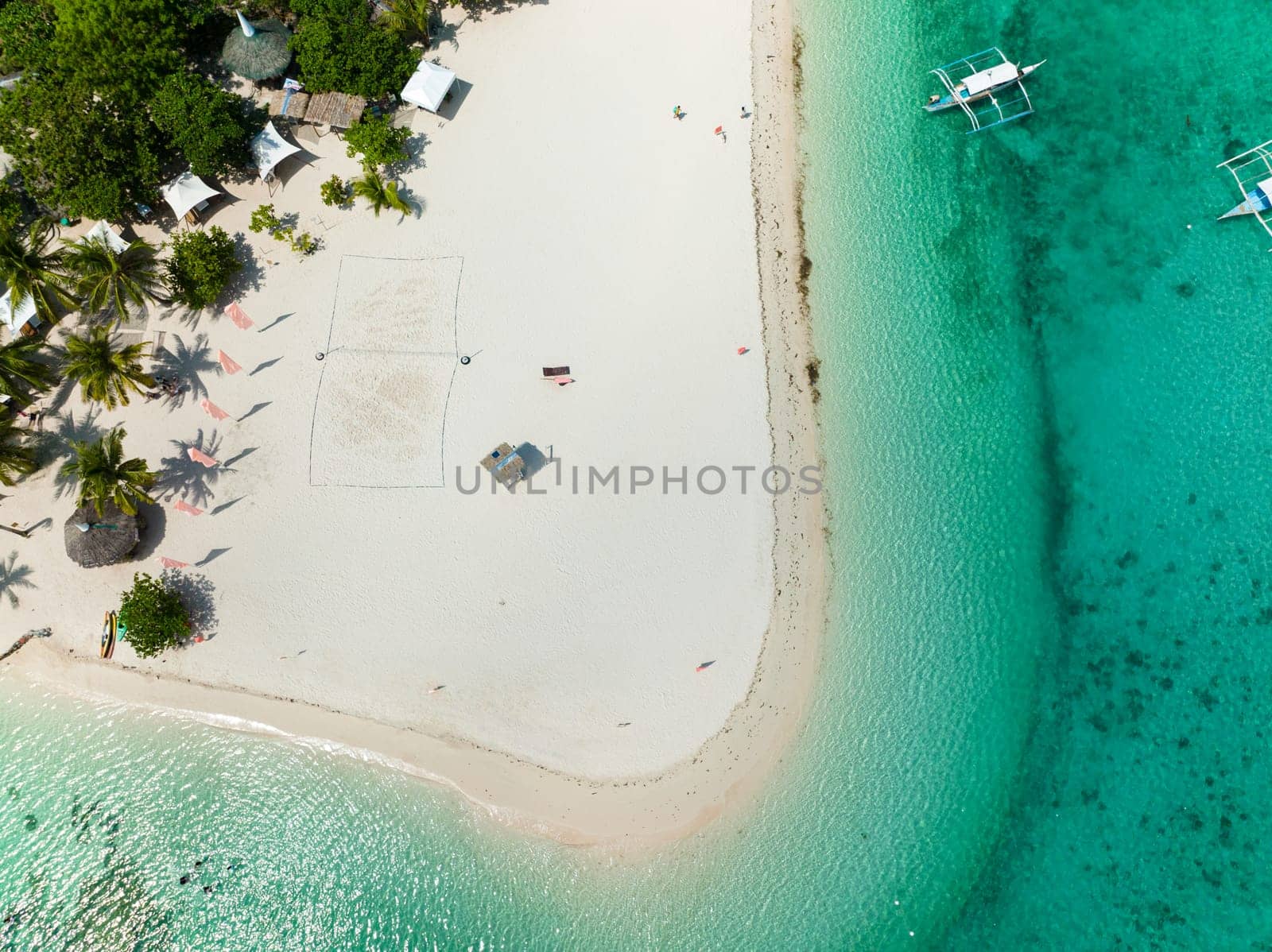 Top view of beautiful beach, palm trees by turquoise water. Bantayan island, Philippines.