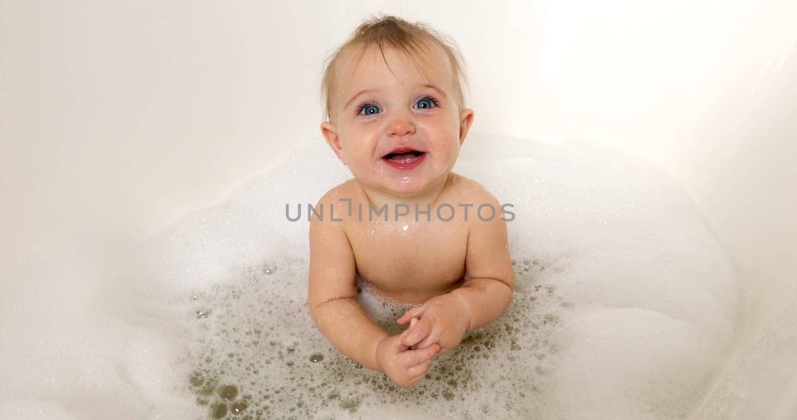 happy baby boy laughing in bath tub by Demkat