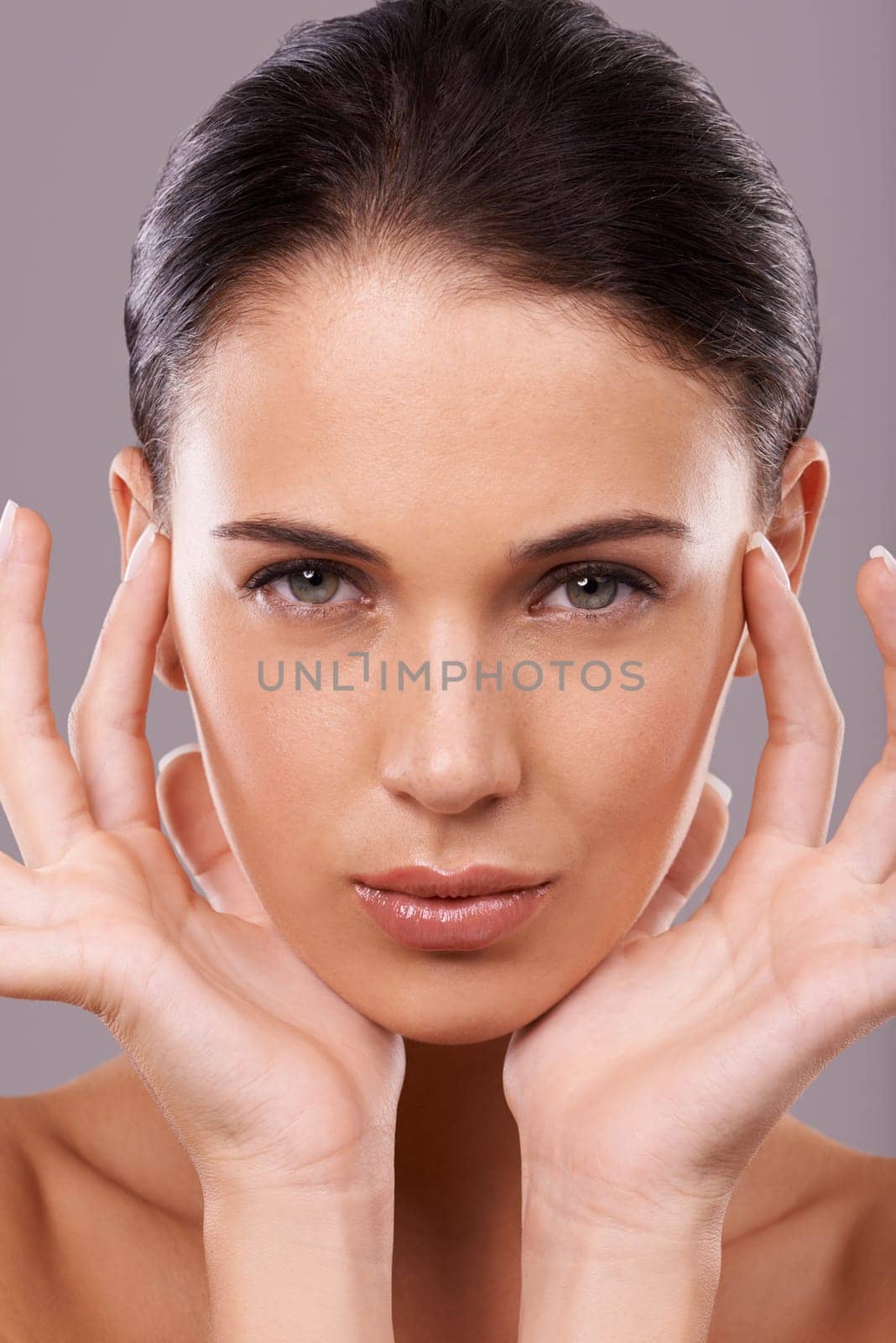 Gorgeous in every way. Beauty shot of a beautiful young woman with perfect skin against a gray background