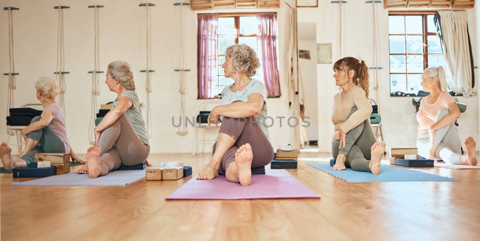 Yoga, personal trainer and senior women community, group and support for healthy life, wellness and body stretching. Elderly, coach and yoga class people on floor in pilates, cardio or workout studio by YuriArcurs
