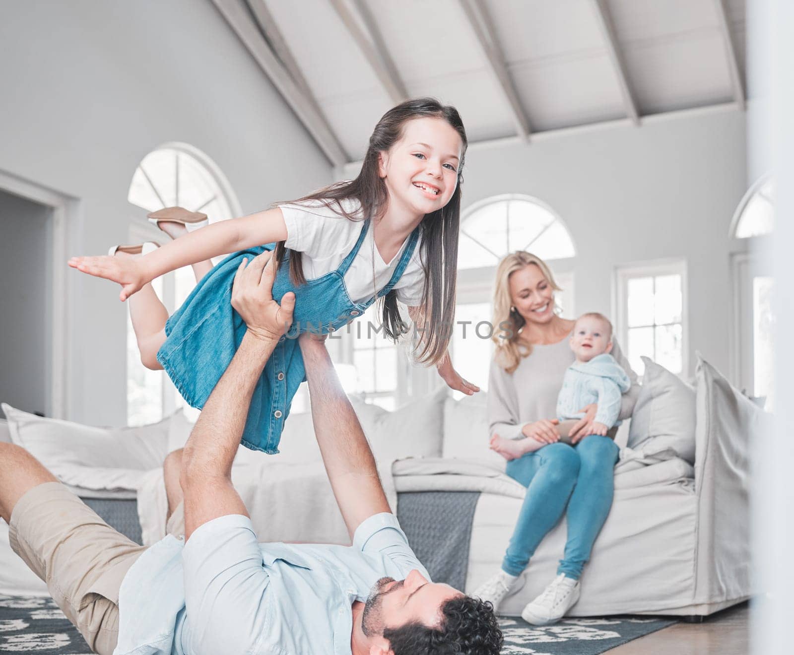 Happy, airplane and family playing in the living room together while bonding in their modern home. Happy, smile and parents relaxing with their children with love, care and happiness in a house