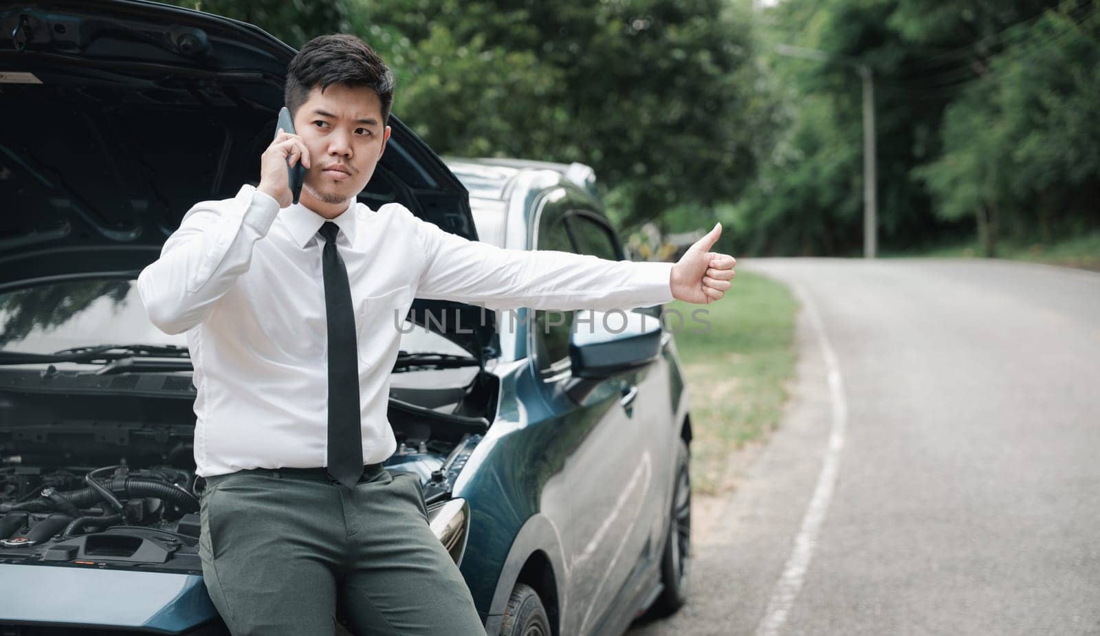 Asian businessman stranded on the road after car breakdown by Sorapop