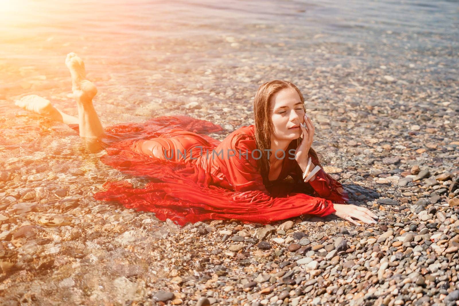 Woman travel sea. Happy tourist taking picture outdoors for memories. Woman traveler looks at the edge of the cliff on the sea bay of mountains, sharing travel adventure journey.