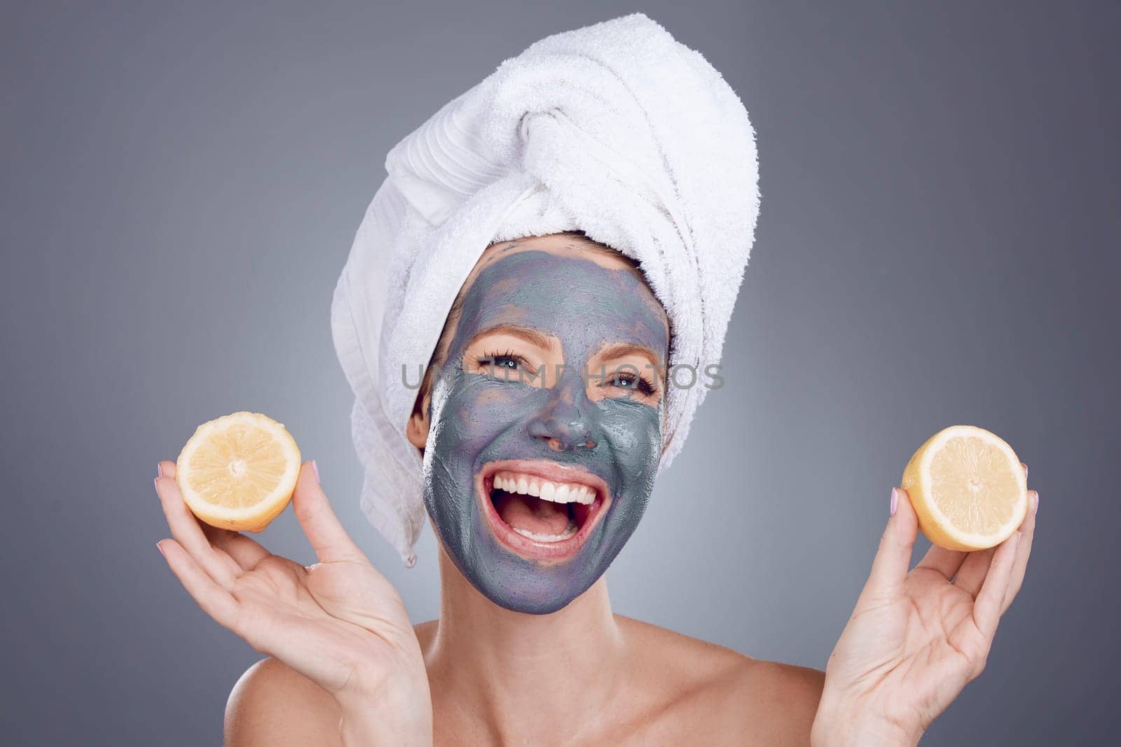 Lemon mask, clay and woman for healthy facial, beauty portrait and anti aging wellness makeup in studio. Happy female model, citrus fruits and vitamin c for charcoal product, shower and laughing face by YuriArcurs