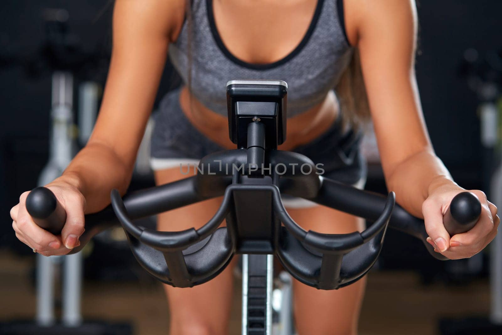 Sport young woman on a stationary bike in the gym
