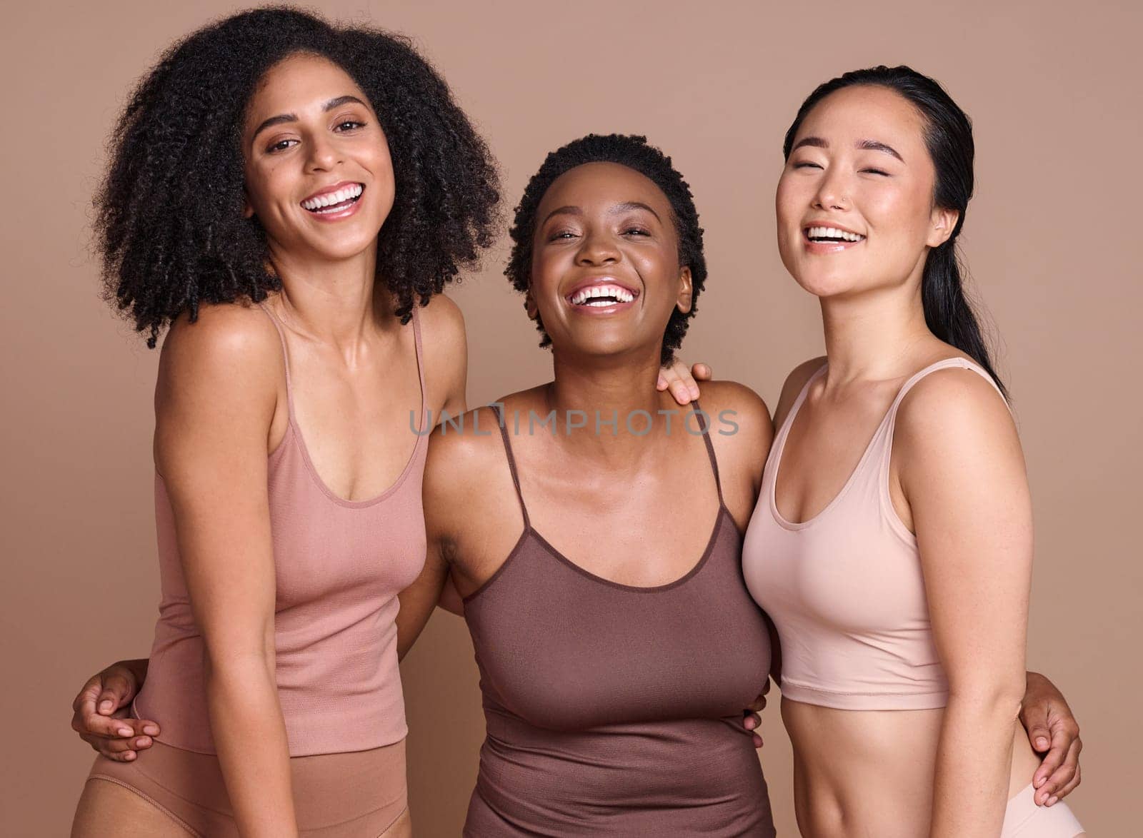 Portrait, diversity and women for body positivity, cosmetics and natural beauty on brown studio background. Multiracial, females and ladies with makeup, support and solidarity for skincare and smile