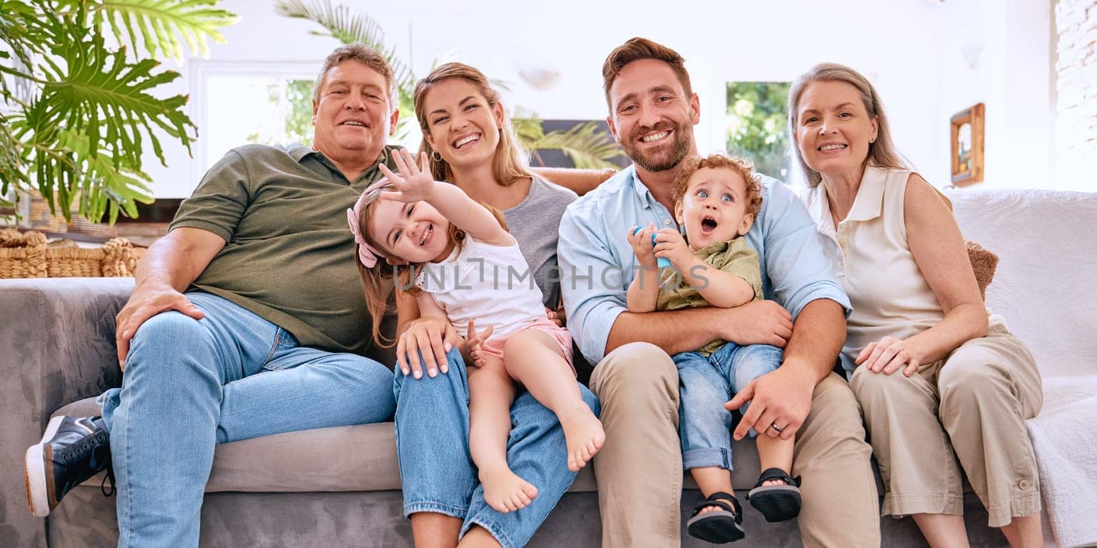 Happy family with kids, parents and grandparents on sofa with smile in living room. Happiness, family and generations of men, women and children spending time in home together making happy memories