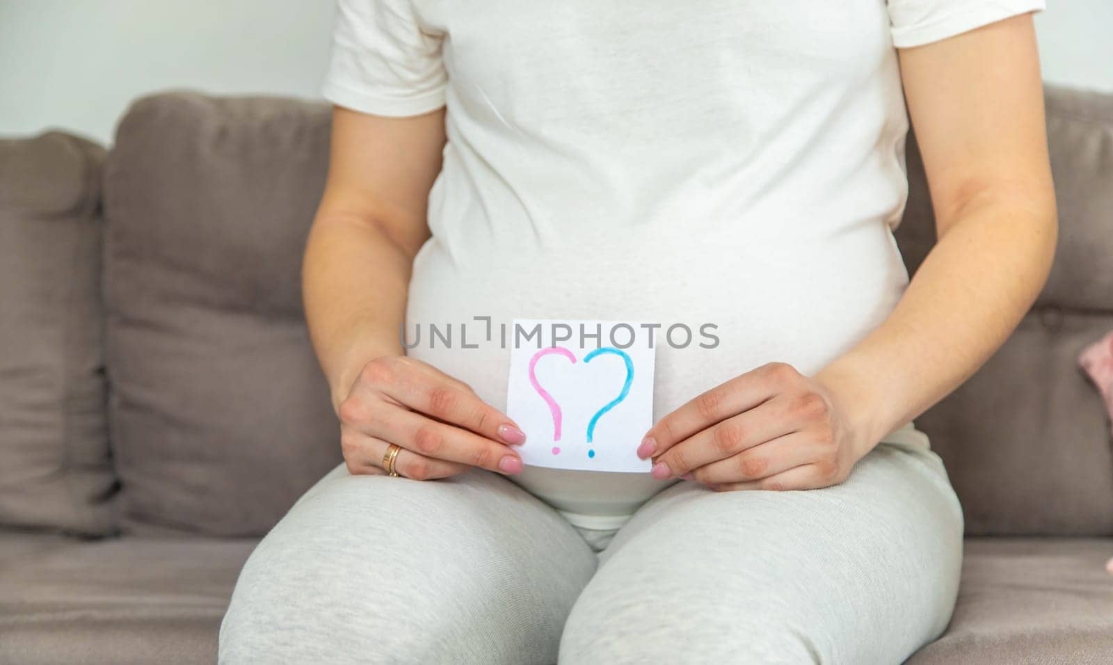 Pregnant woman who will be the question mark. Selective focus. Cute.