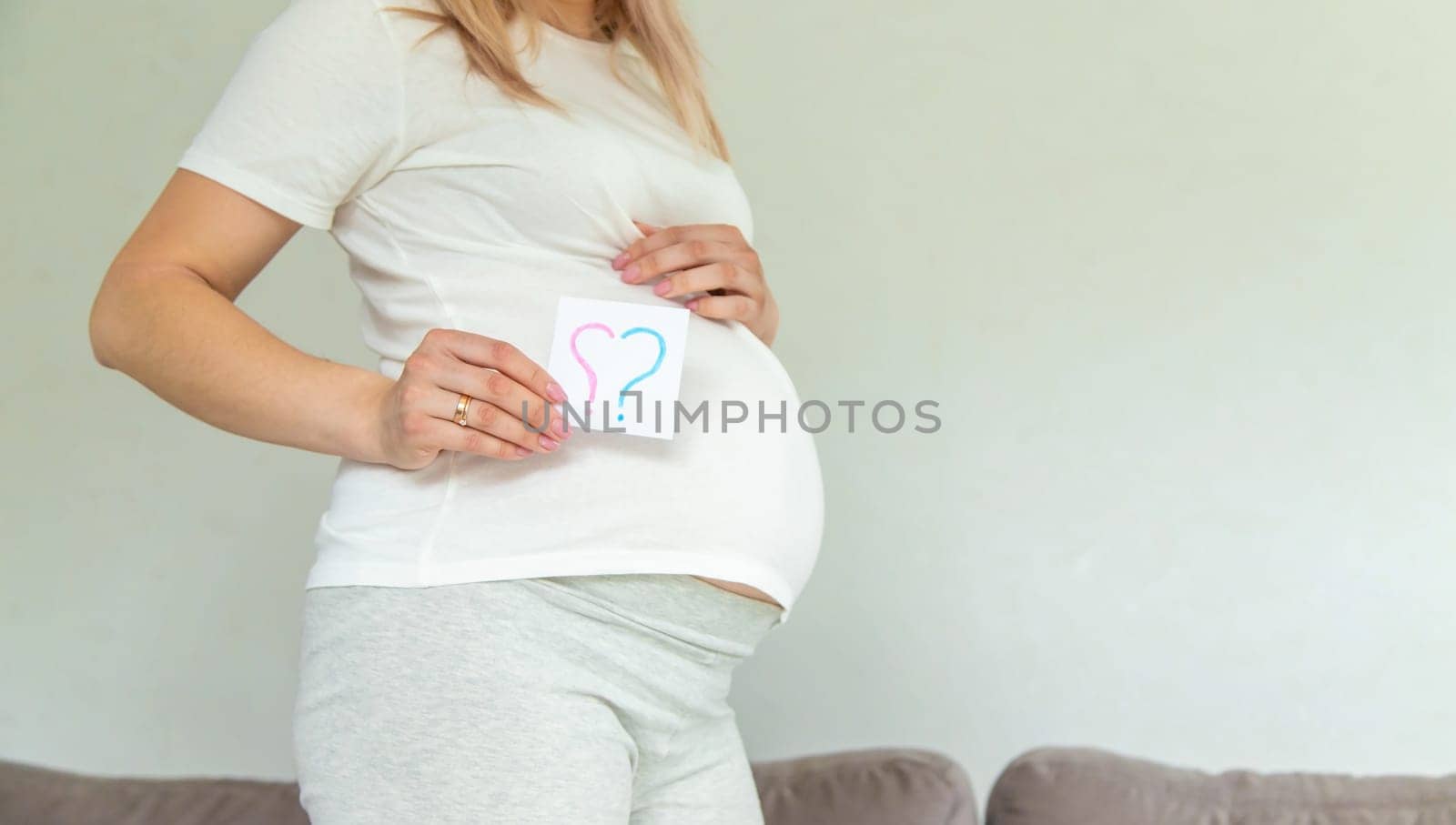 Pregnant woman who will be the question mark. Selective focus. Cute.