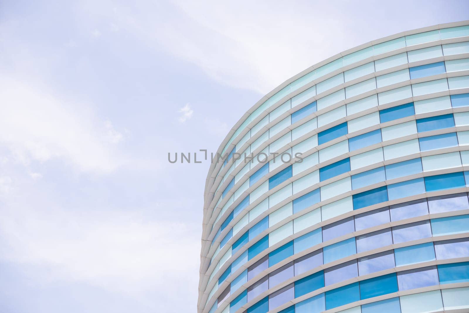 Abstract image of the facade of a modern building covered in reflective plates and glass