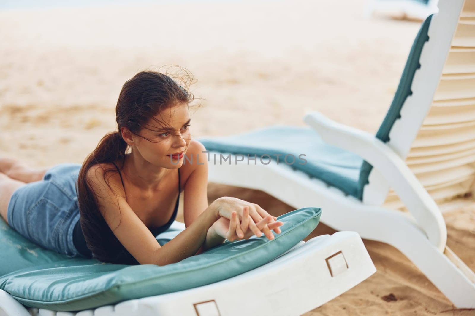 beautiful woman resort enjoy tropical travel brunette ocean sunbed long sea beach young sun smiling sand lying hair lifestyle sunglasses relaxation female