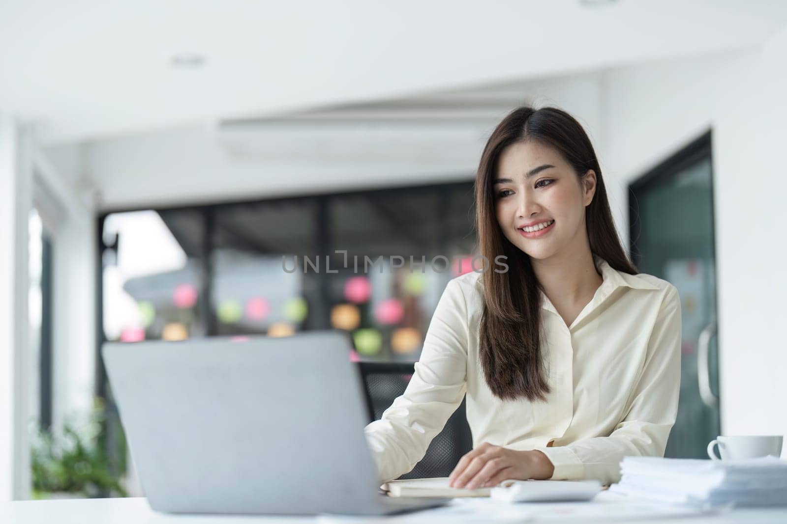 business young woman happy cheerful cute beautiful business woman sit in office using laptop computer.