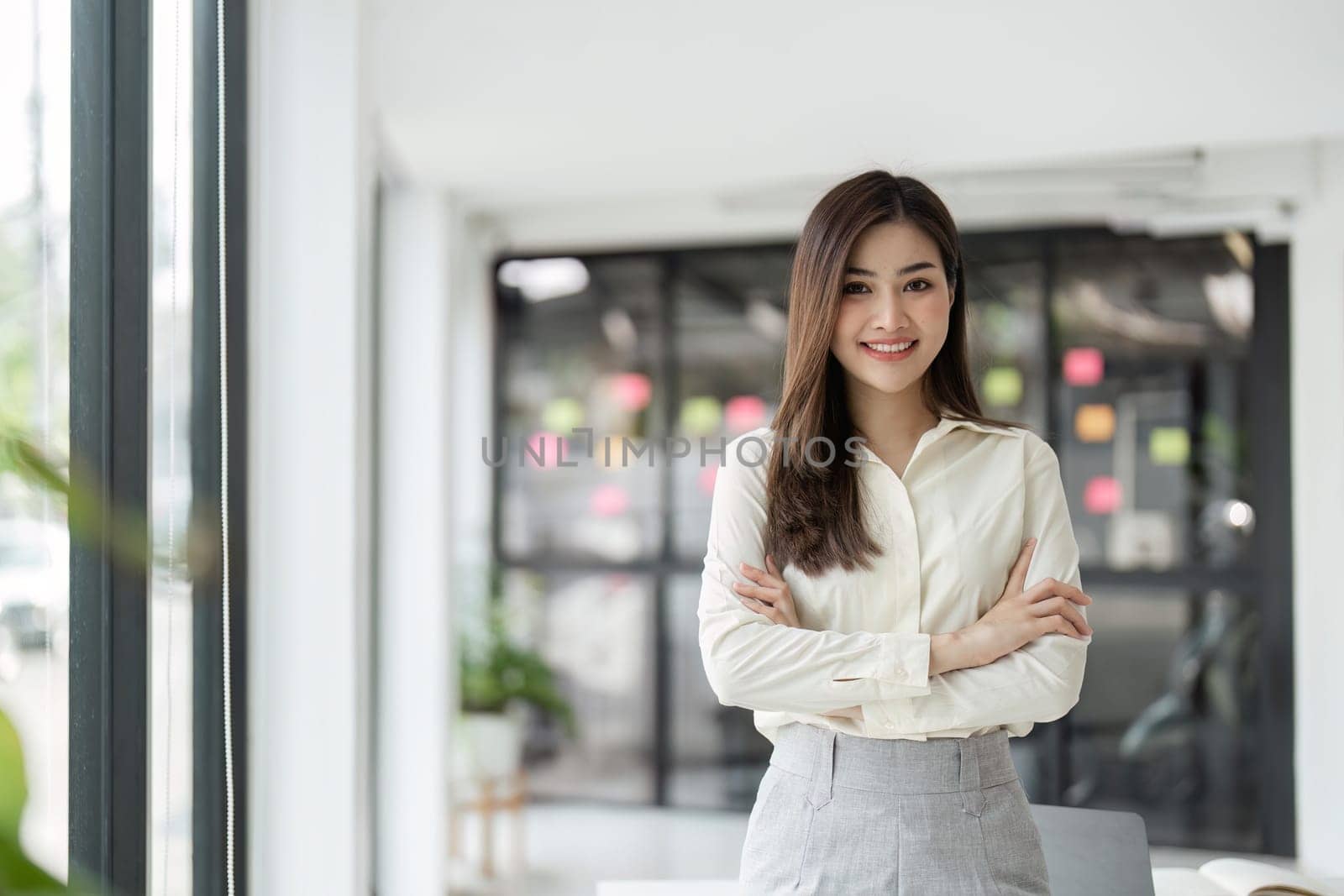 Portrait of businesswoman in office looking at camera. Confident business woman with.