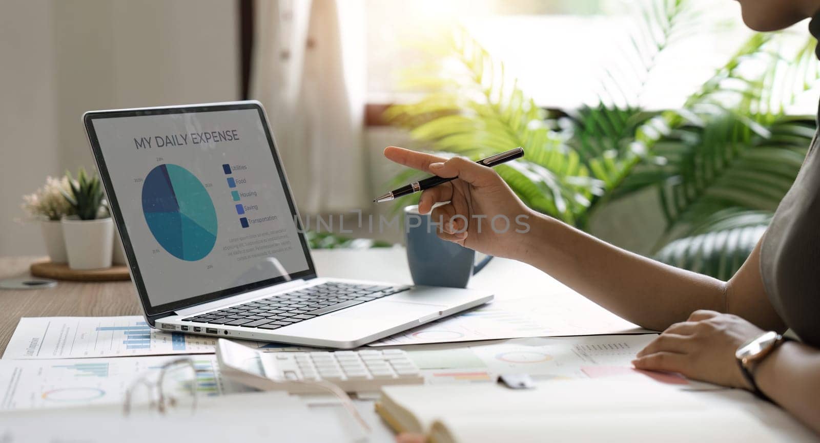 Asian businesswoman sit at their desks at office and calculate financial graphs showing results about their investments, plan a successful business growth process, diagrams on screen.
