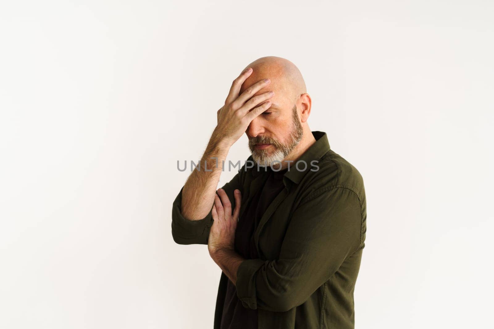 Man making facepalm gesture, expressing frustration and disappointment. Concept of problems and challenges depicted through gesture and facial expression, conveying sense of stress and exasperation. . High quality photo