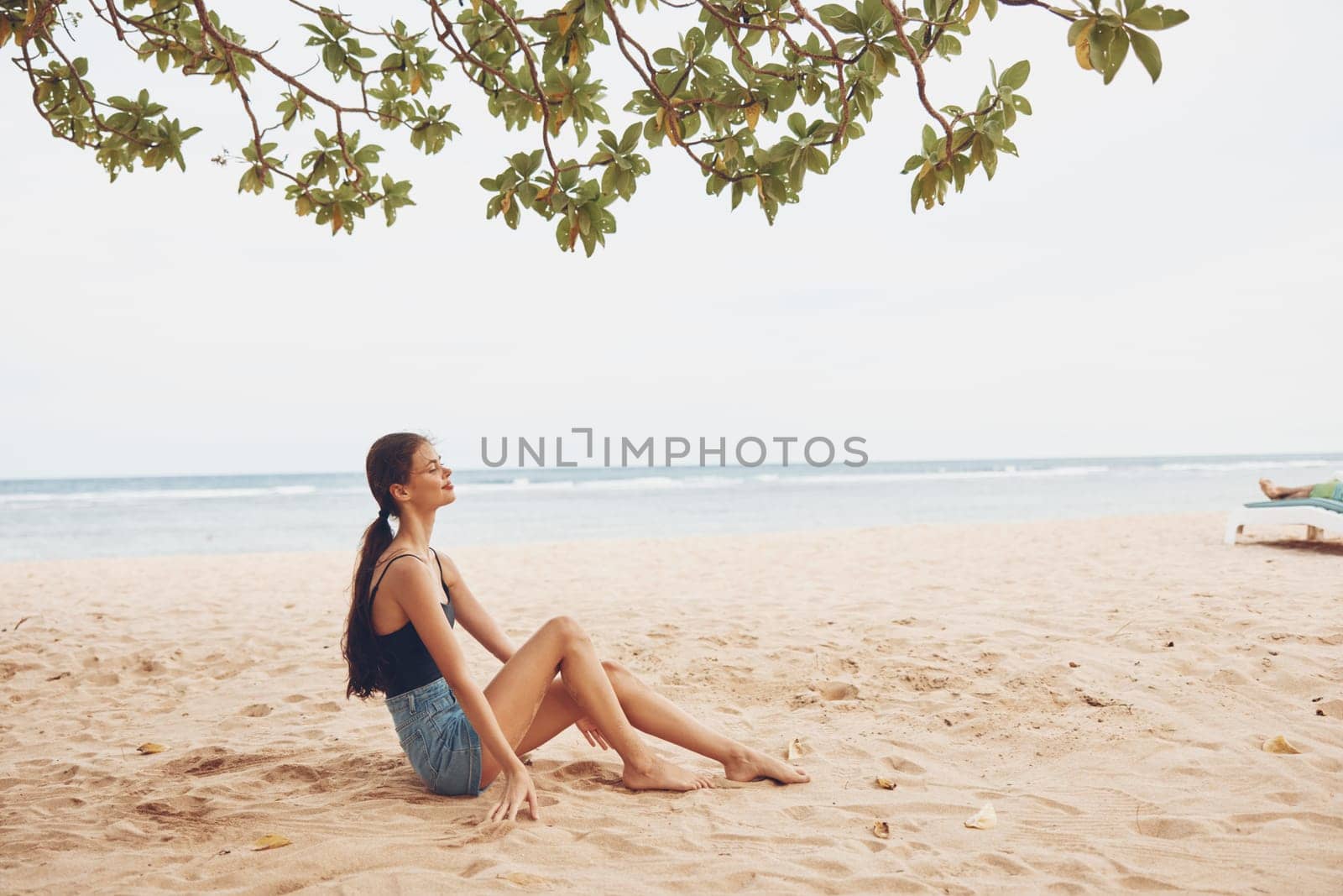 woman beautiful body holiday beach sand pretty sitting travel sea smile carefree freedom back relax young view natural girl nature vacation female