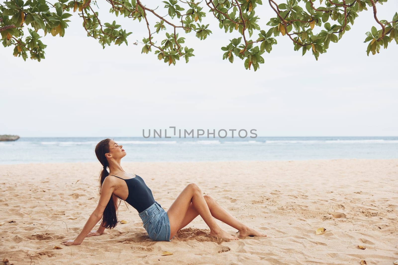 woman vacation relax sand fashion travel hair sea carefree lifestyle sitting beach freedom girl nature smile alone model beautiful sexy back view