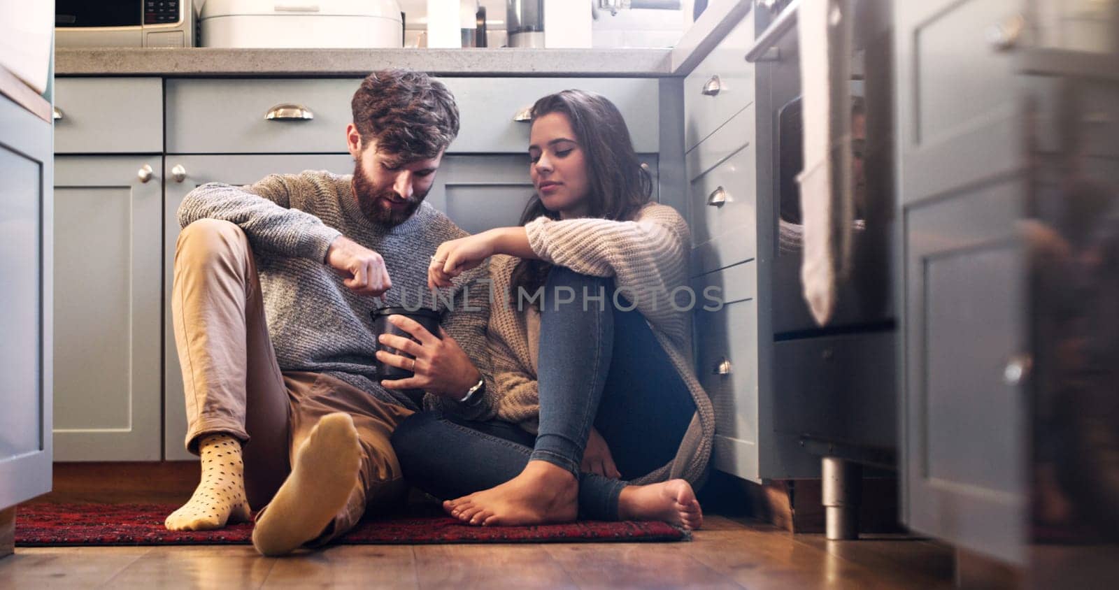 Ice cream, love and couple on kitchen floor for bonding, relax and quality time together at home. Dating, relationship and happy man and woman with sweet food, dessert and marriage with romance by YuriArcurs