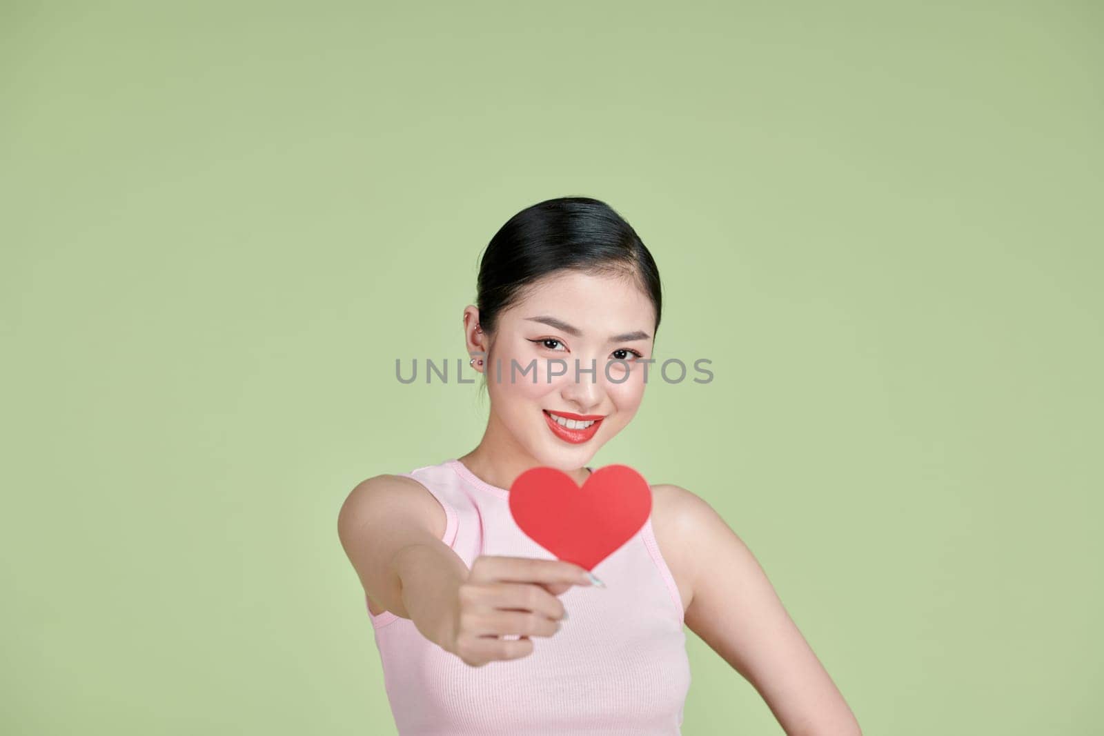 Beautiful woman in love and holding heart shape