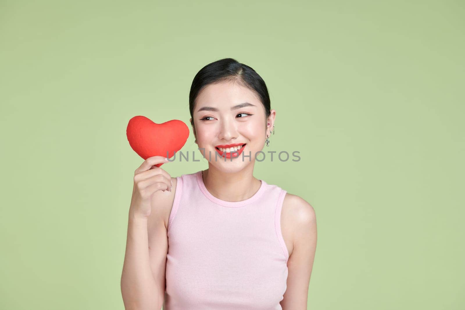 Asian woman with red heart on white background by makidotvn